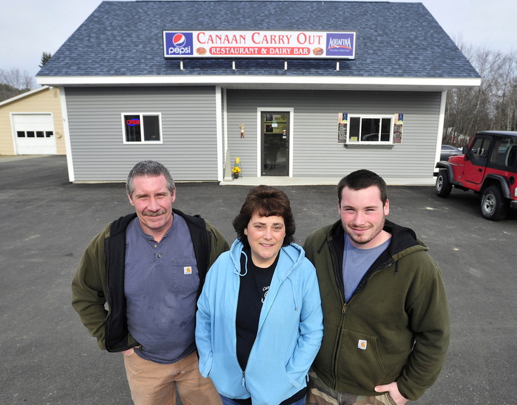 CANAAN CARRY OUT: Tim and Jane LaPlant, and their son T.J. stand in front of their new business Canaan Carry Out on Main Street in Canaan on Friday. The LaPlants are happy with the proposed $3 million-plus U.S. Route 2 state road improvement project.