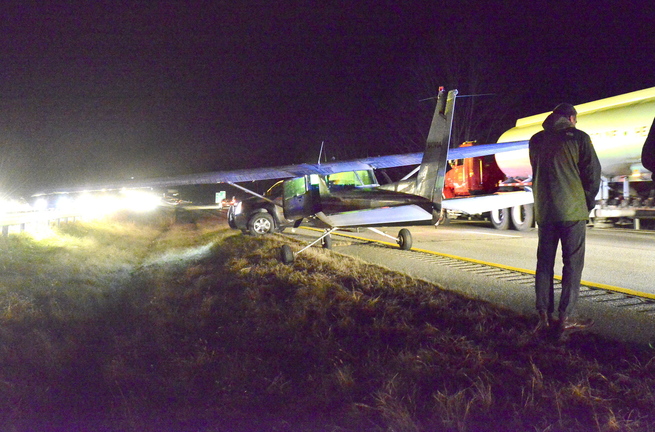 Pilot Sachin Hejaji of Falmouth talks on his phone after making an emergency landing of a small plane in the southbound lane of Interstate 295 around mile 13 in Cumberland about 5 p.m. Thursday.