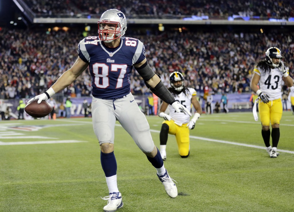 New England Patriots tight end Rob Gronkowski celebrates his touchdown catch in front of Pittsburgh Steelers safeties Ryan Clark, back left, and Troy Polamalu (43) during the second quarter of an NFL football game Sunday, Nov. 3, 2013, in Foxborough, Mass.