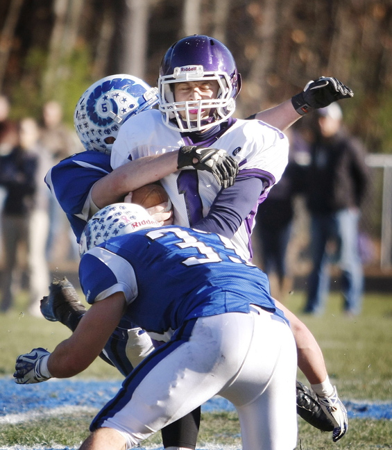 Marshwood #1 Luc Blanchette is surrounded by Kennebunk defenders #3 Chris Broadhead and #33 Nicco DeLorenzo during first half action in the Western Class B regional final at Kennebunk High School Saturday, Nov. 16, 2013. Jill Brady/Staff Photographer.