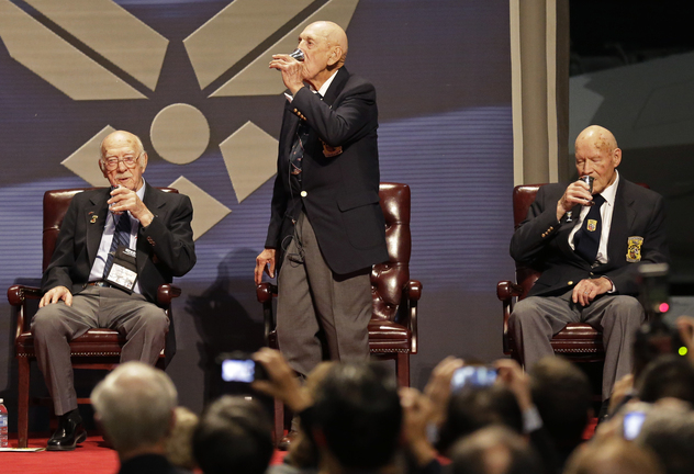 Richard Cole, center, proposes a toast with two other surviving members of the 1942 Tokyo raid led by Lt. Col. Jimmy Doolittle, Edward Saylor, left, and David Thatcher, Saturday, Nov. 9, 2013, at the National Museum for the US Air Force in Dayton, Ohio. The fourth surviving member, Robert Hite, was unable to travel to the ceremonies.