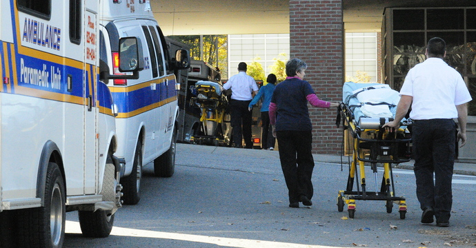 Staff photo by Joe Phelan On the Move: Paramedics and transport nurses roll empty stretchers into the former Augusta MaineGeneral hospital as they work to move patients from there to the new Alfond Center for Health early in the morning on Saturday in Augusta.