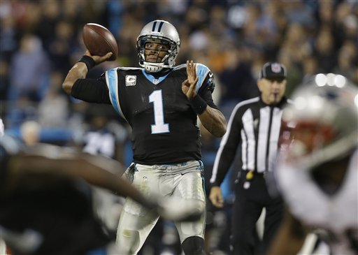 Carolina Panthers quarterback Cam Newton (1) works against the New England Patriots during the second half of an NFL football game in Charlotte, N.C., Monday, Nov. 18, 2013. (AP Photo/Gerry Broome)