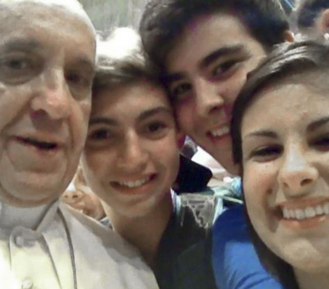 Pope Francis has a “selfie” taken inside St. Peter’s Basilica with youths from the Italian Diocese of Piacenza and Bobbio who came to Rome for a pilgrimage.