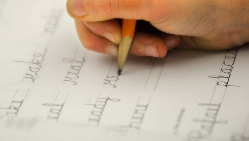 UP close: A Chelsea Elementary third-grader works on a cursive lesson during a recent class.