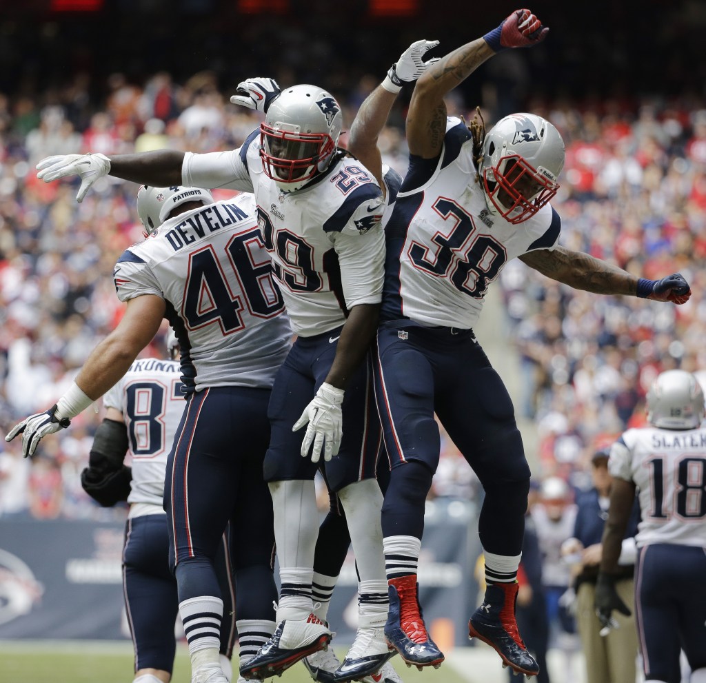 New England Patriots' LeGarrette Blount (29) celebrates with teammates James Develin (46) and Brandon Bolden (38) after scoring a touchdown against the Houston Texans during the fourth quarter of an NFL football game on Sunday, Dec. 1, 2013, in Houston. (AP Photo/David J. Phillip)