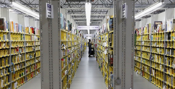 An Amazon.com employee stocks a shelf at an Amazon.com Fulfillment Center on “Cyber Monday” the busiest online shopping day of the holiday season, Monday in Phoenix.