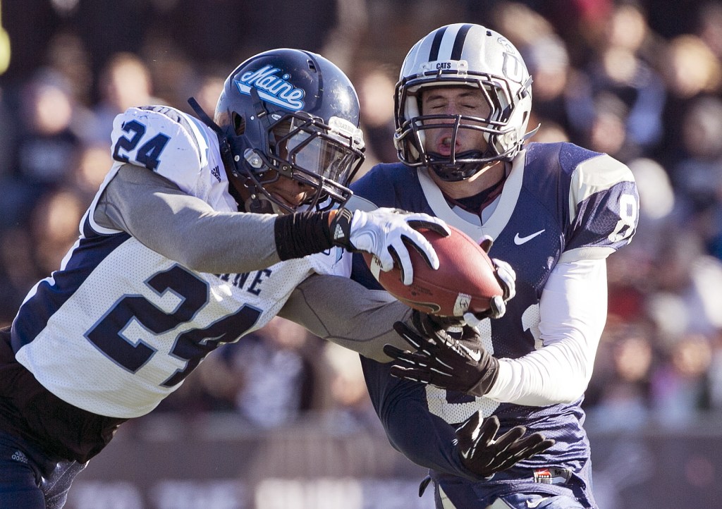 Maine defensive back Khari Al-Mateen (24) breaks up a pass intended for New Hampshire wide receiver Jared Allison (8) in the first half of an NCAA college football game Saturday, Nov. 23, 2013, in Durham, N.H. (AP Photo/Robert F. Bukaty)