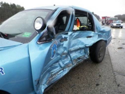 Maine State Police Trooper William Baker suffered bumps and bruises when his cruiser was struck on the Maine Turnpike in York on Sunday. The cruiser was destroyed.