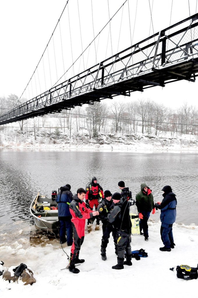 LOOKING FOR EVIDENCE: Divers with the Maine State Police prepare to enter the Kennebec River under the Two-Cent Bridge in Waterville Monday in a search for evidence related to the death of a Waterville man two weeks ago. The man accused of the murder of Thomas Namer may have been on the Two-Cent Bridge or near it within hours of the killing, according to police.