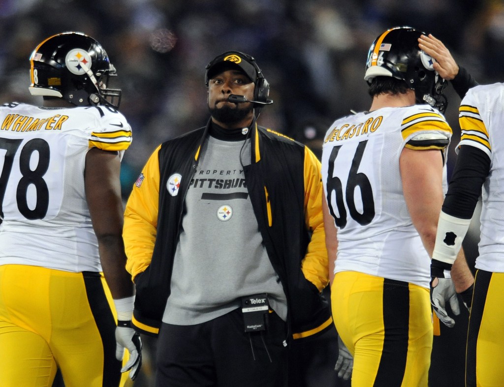 FILE - In this Nov. 28, 2013 file photo, Pittsburgh Steelers coach Mike Tomlin stands on the sideline during an official play review in the second half of an NFL football game against the Baltimore Ravens, in Baltimore. Tomlin has been fined $100,000 for interfering with a play against the Baltimore Ravens on Thanksgiving. The NFL also said Wednesday, Dev. 4, 2013, that it would consider docking Pittsburgh a draft pick “because the conduct affected a play on the field.”