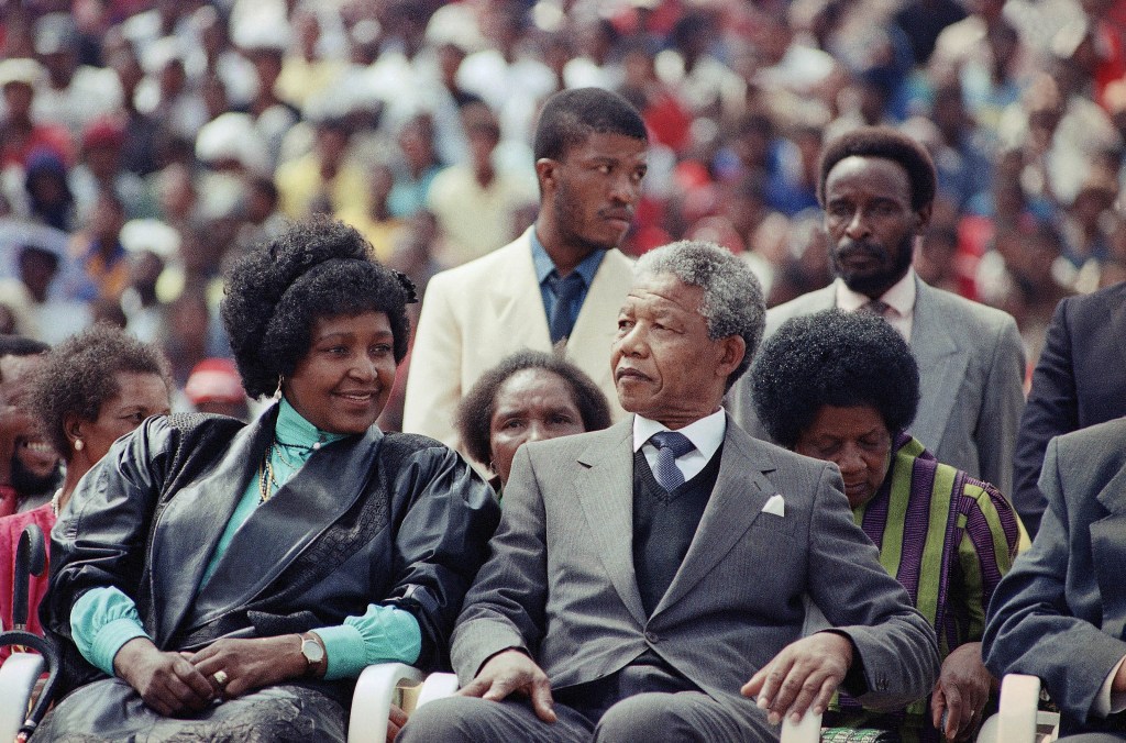In this Feb. 13, 1990 file photo, Nelson Mandela, right, with his wife, Winnie, participate in a South African Communist Party Rally in the fully-packed Soccer City stadium in Soweto, South Africa, shortly after his release from 27 years in prison. South Africa’s President Jacob Zuma said, Thursday, Dec. 5, 2013, that Nelson Mandela has died. He was 95.