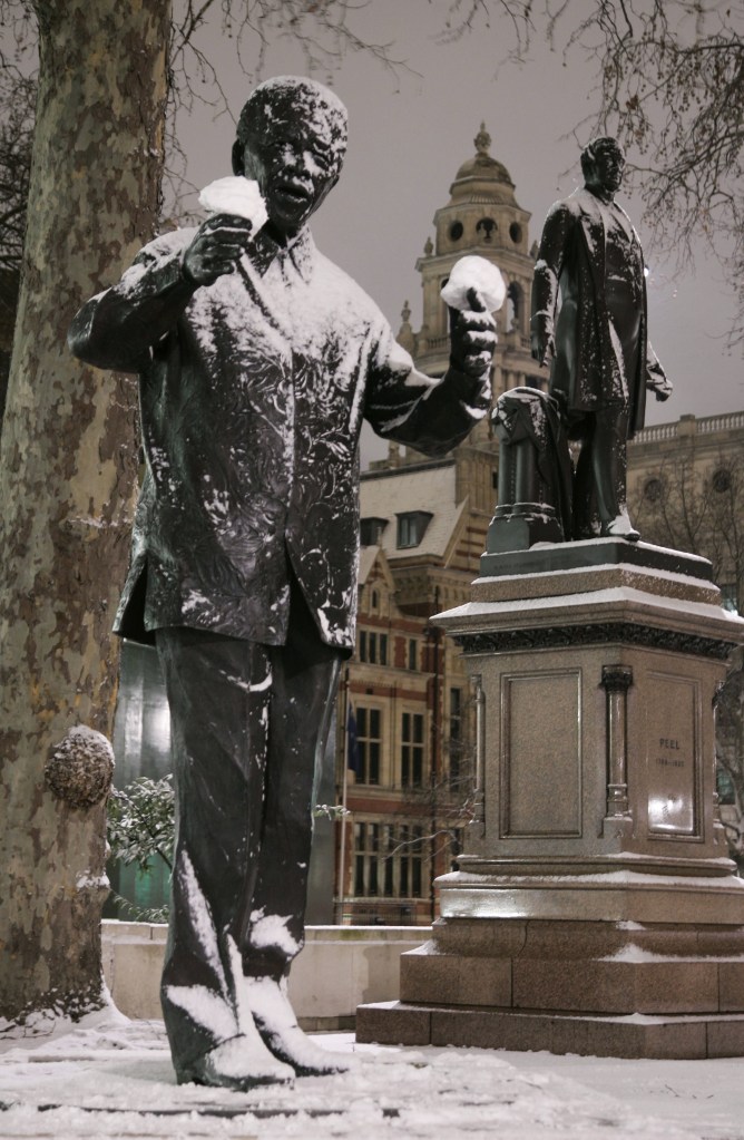 FILE - Snowballs rest on the hands of a statue of former South African President Nelson Mandela in London's Parliament Square in this Feb. 1, 2009 file photo. On Thursday, Dec. 5, 2013, Mandela died at the age of 95. (AP Photo/Sang Tan, File)