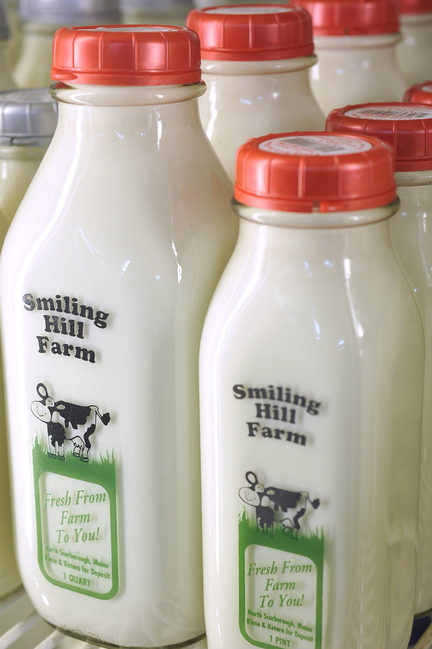 Bottles of milk are lined up at Smiling Hill Farm in Westbrook on Thursday. The dairy version of a fiscal cliff looms, industry and economic experts say.