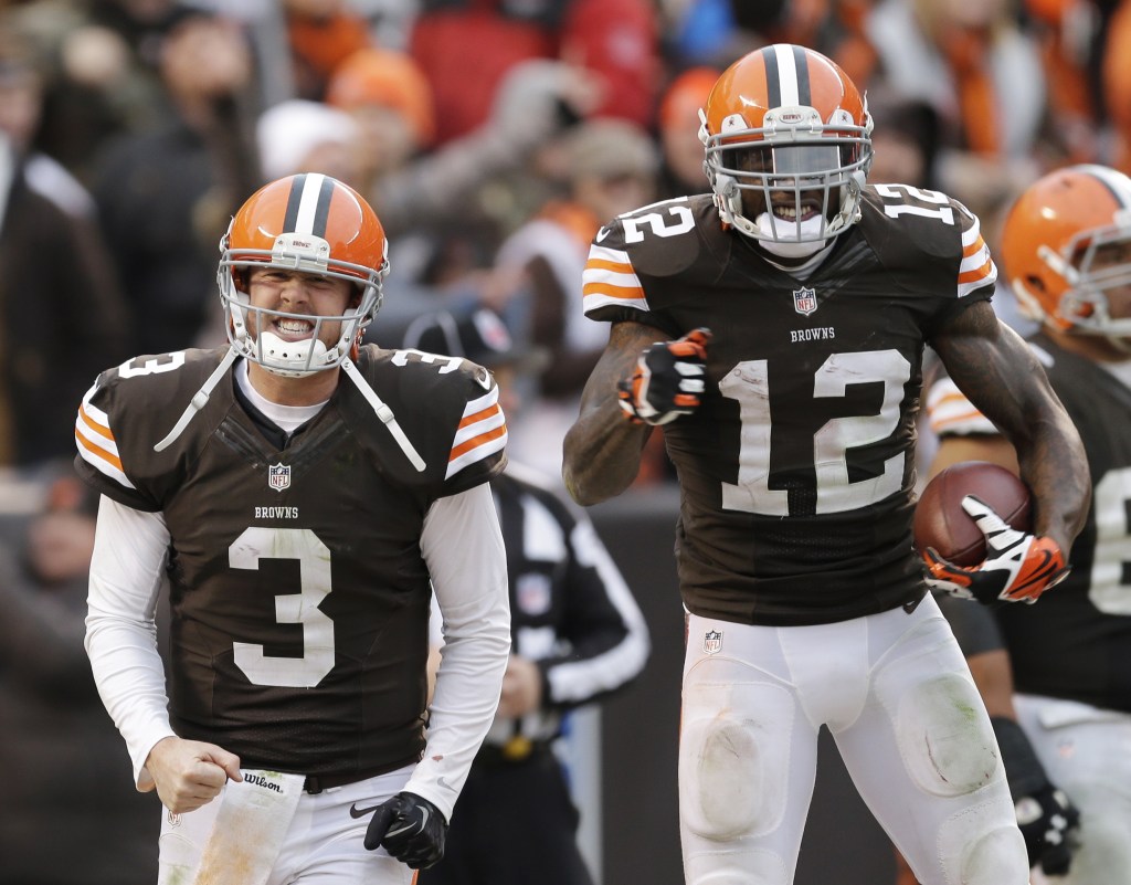 Cleveland Browns quarterback Brandon Weeden (3) celebrates with wide receiver Josh Gordon (12) after they connected on a touchdown pass in a game against the Jacksonville Jaguars on Sunday.