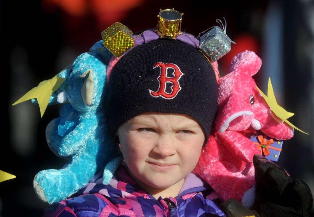 Styling: Madissynn Sutton, 7, wears a pair of stuffed elephant earmuffs at the annual Chester Greenwood Day parade in downtown Farmington on Saturday.
