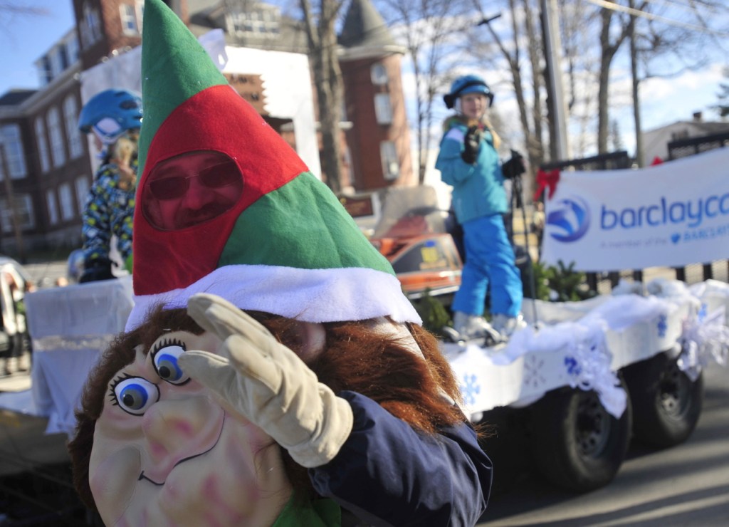 In the spirit: Dan Farrington, dressed as an elf, waves to the crowd on Main Street during the annual Chester Greenwood Day parade in downtown Farmington on Saturday.