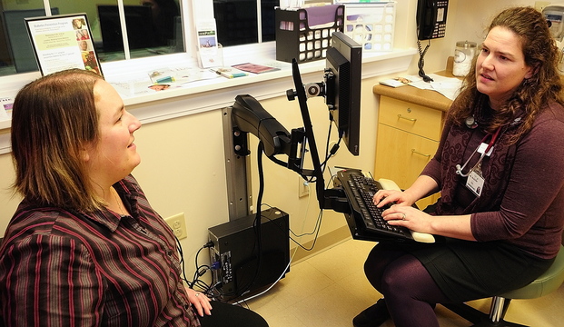 MEDICAL CHOICES: Crystal Beaulieu, left, talks with Dr. Michelle Mosher during an office visit on Friday at Winthrop Family Medicine in Winthrop, which recently received a grant that encourages physicians to talk to patients about conducting tests only when they add value to a diagnosis.