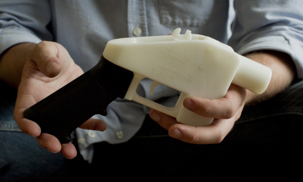 2013 Associated Press File Photo Cody Wilson holds what he calls a Liberator pistol that was completely made on a 3-D-printer at his home in Austin, Texas. Congress is extending a ban on plastic firearms that can slip past airport and school metal detectors and X-ray machines.