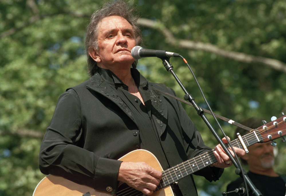 File photo, Johnny Cash performs at a benefit concert in Central Park in New York. Cash’s album, “Out Among the Stars,” comprised of 12 studio recordings recently discovered, is releasing March 25, 2014.