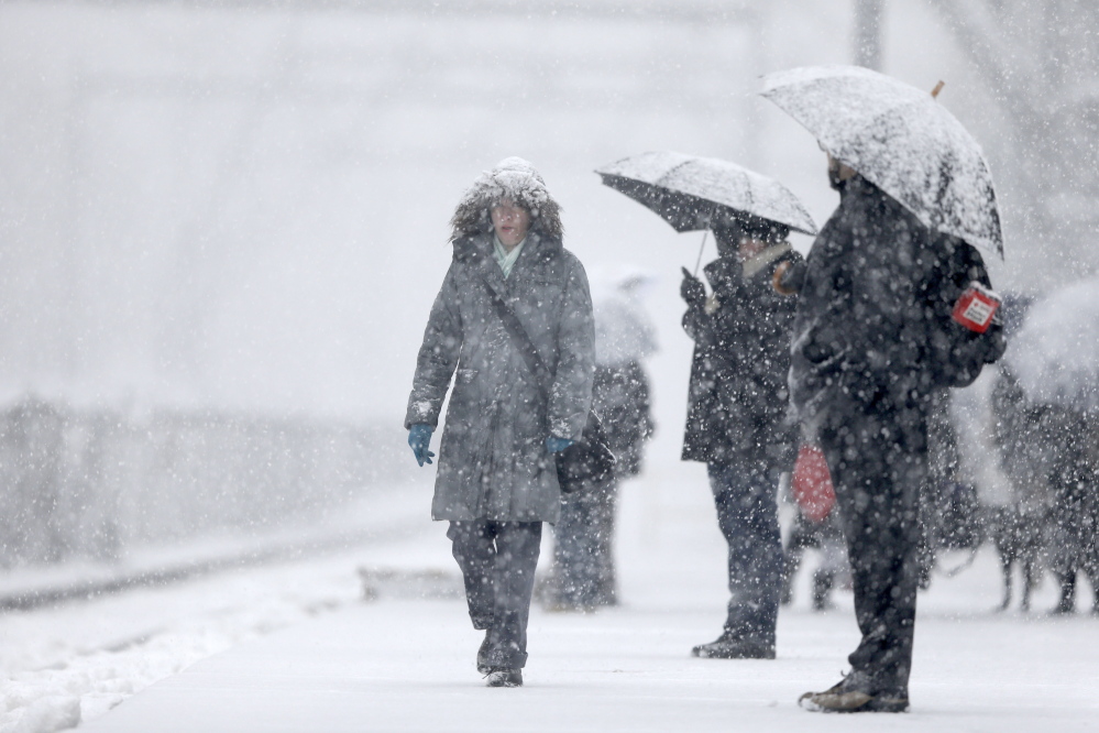The Associated Press Commuters wait for a train in Philadelphia Tuesday morning. Accumulations of 3 to 6 inches were expected as the National Weather Service issued a winter storm warning for the Eastern Seaboard, including Baltimore, Washington, D.C., Philadelphia and Wilmington, Del.