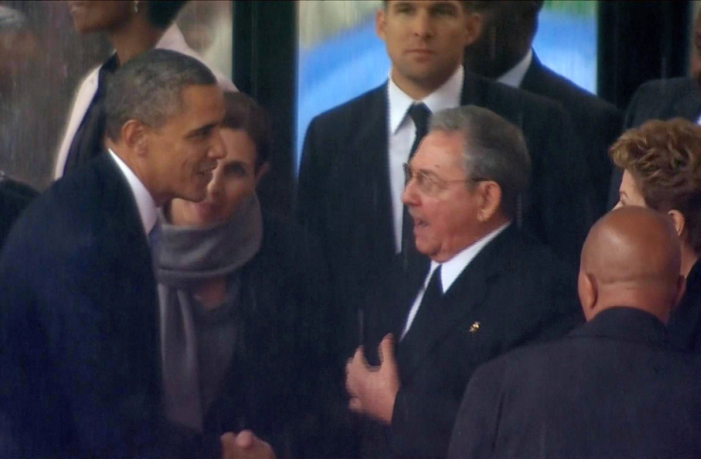 In this image from TV, President Barack Obama shakes hands with Cuban President Raul Castro at the FNB Stadium in Soweto, South Africa, Tuesday. The handshake between the leaders of the two Cold War enemies came during a ceremony that was focused on Mandela’s legacy of reconciliation.