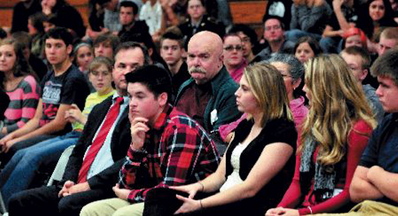 appeal Fails: Al Althenn, center, of China, looks at Nokomis Regional High School student Katie Manzo, at right, as she asks questions during a break in hearings in October at the Newport school with Justices of the Maine Supreme Judicial Court.