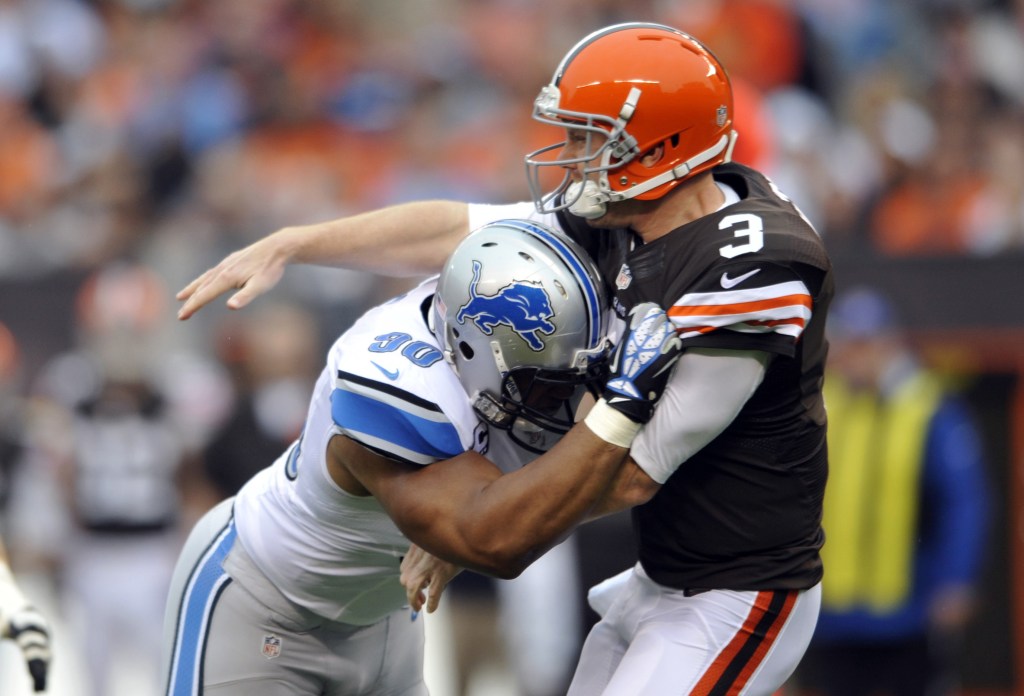 Cleveland Browns quarterback Brandon Weeden (3) is hit by Detroit Lions defensive tackle Ndamukong Suh after throwing a pass in a game in Cleveland on Oct. 13. Suh wasn’t penalized on the play, but was reportedly fined by the league for the hit.