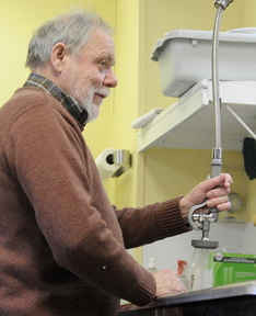 Support: Michel Tessier, of Dresden, washes a dish Tuesday at the Bread of Life Soup Kitchen in Augusta. Tessier said he likes the openness Pope Francis has exhibited since becoming the leader of the Catholic Church. Tessier helps three days a week at the kitchen, which his wife, Patsy, manages.