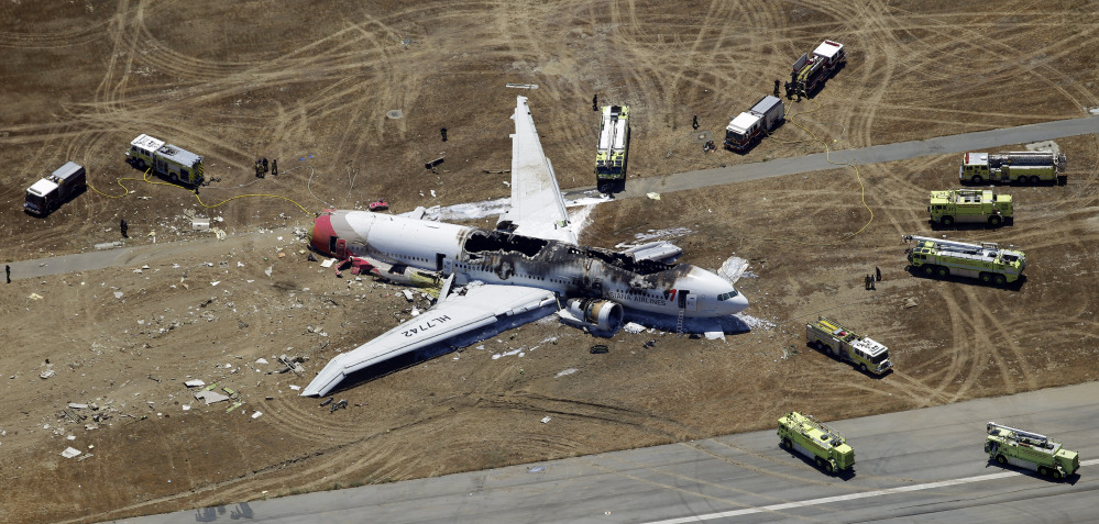 In this Saturday, July 6, 2013, photo, wreckage of the Asiana Flight 214 airplane is seen after it crashed at the San Francisco International Airport in San Francisco.