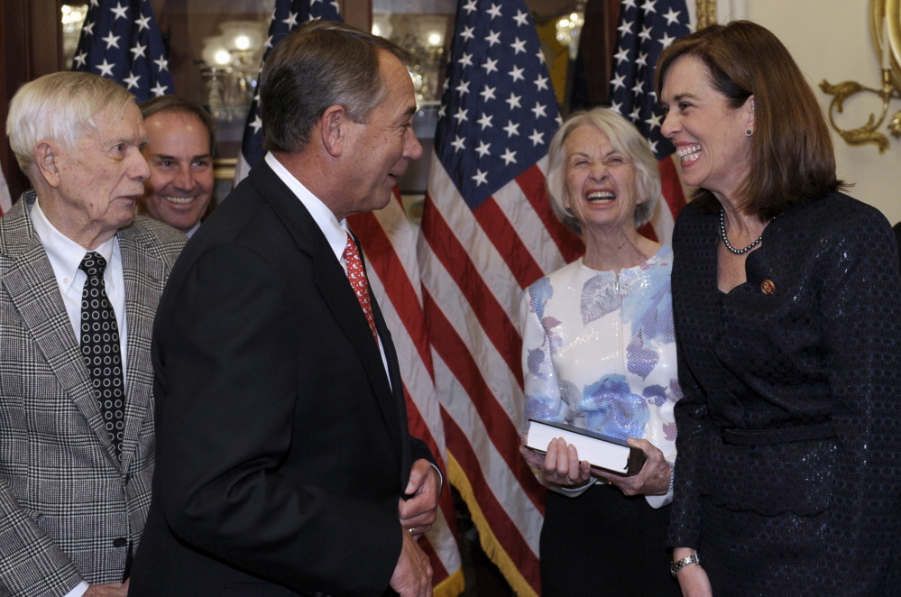 House Speaker John Boehner, R-Ohio, third from left, shares a laugh Thursday with Katherine Clark, D-Mass., before posing for a ceremonial swearing-in on Capitol Hill. Others in the photo are, from left, Clark’s father, Chan Clark, husband, Rodney Dowell, and her mother, Judy Clark.