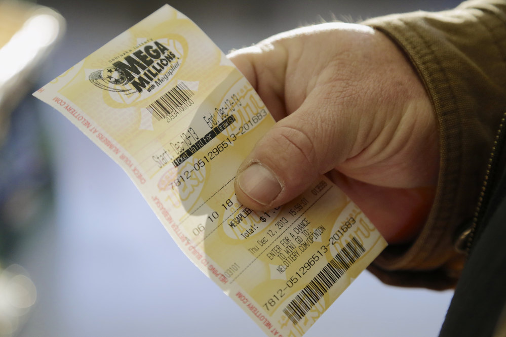 Pete Sturtevant holds Thursday, Dec. 12, 2013, a Mega Millions ticket he bought at the Speedee Mart store in Gretna, Neb., where someone bought a winning Powerball ticket the previous day. Lottery officials behind Mega Millions say the lesser known game alongside Powerball is grabbing some attention with a $400 million jackpot _ an estimated amount that comes less than two months after a major revamp to the game.