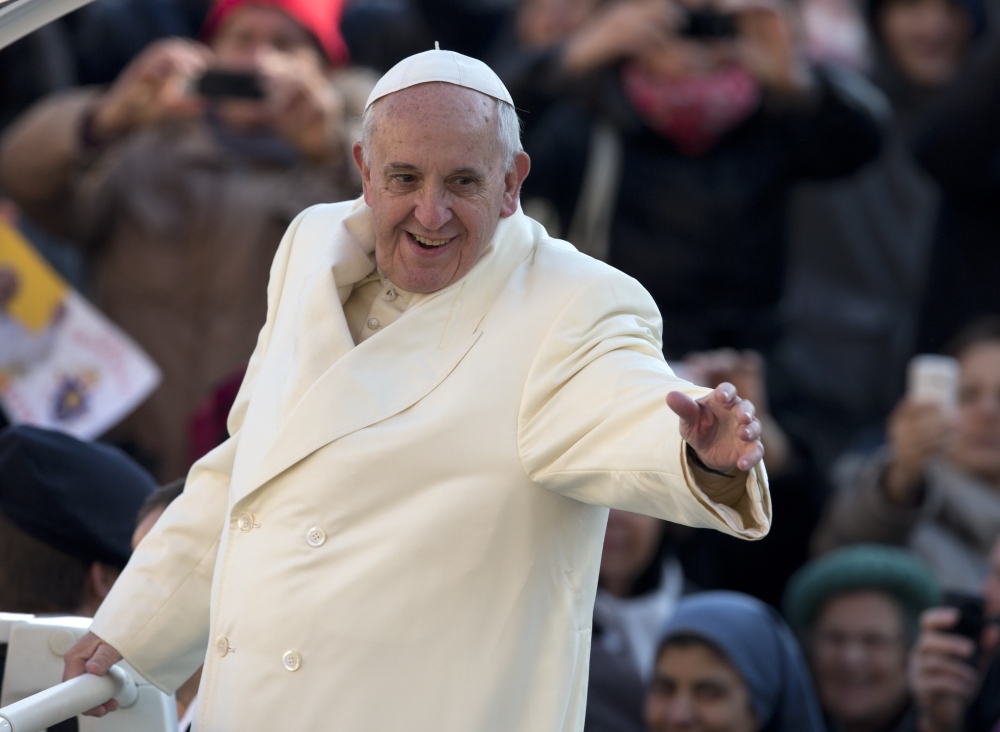 Pope Francis waves as he arrives for his weekly general audience in St. Peter’s Square at the Vatican, Wednesday.