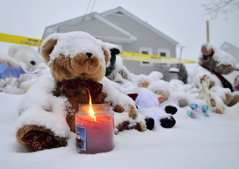 Staff photo by Michael G. Seamans A candle illuminates a growing teddy bear shrine for missing 20-month-old Ayla Reynolds outside her 29 Violette Ave residence in Waterville on Christmas Day.