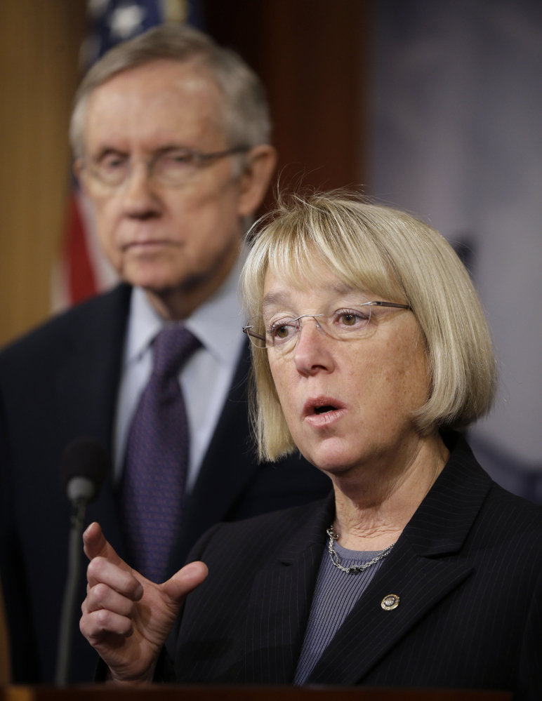 Senate Majority Leader Harry Reid of Nevada listens at left as Senate Budget Committee Chair Sen. Patty Murray, D-Wash., answers questions on the budget Thursday.