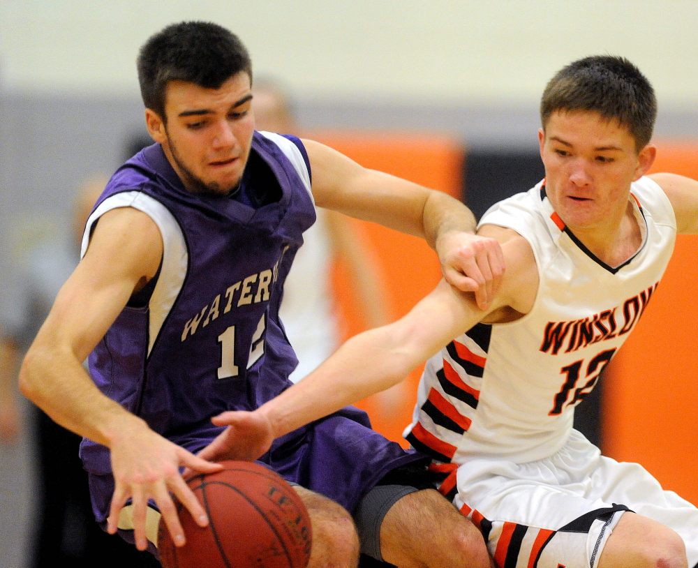 HIGH SCHOOL BASKETBALL: Winslow High School’s Connor Wildes, 12, tries to steal the ball from Waterville Senior High School’s Justin Jabar, 12, in the first quarter in Winslow on Saturday.