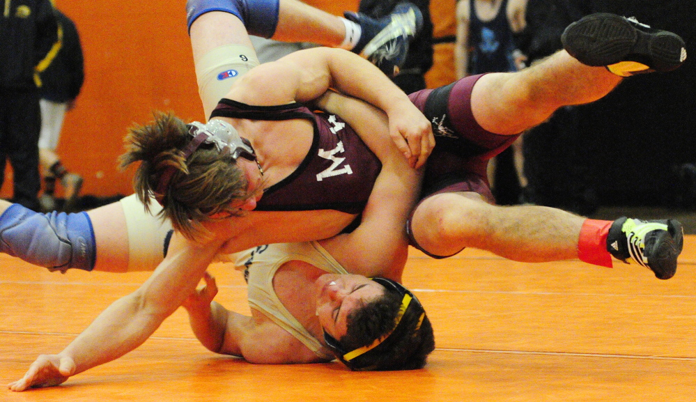 Monmouth Academy’s James Gambino, top, and Mount Blue’s Danny Reed compete in a 138-pound championship semi-finals during the Tiger Invitational on Saturday December 14, 2013 in the John A. Bragoli Memorial Gym in Gardiner.