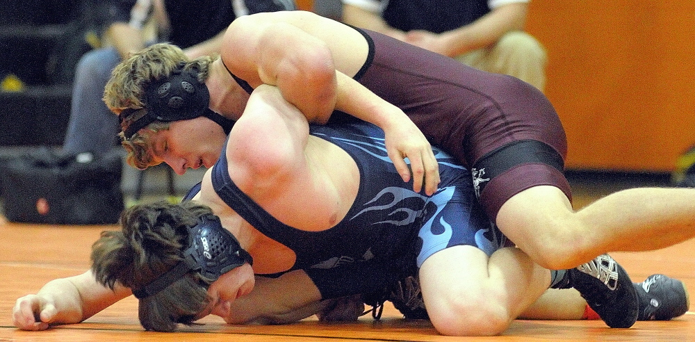 Monmouth Acadmey’s Stuart Buzzell, top, would eventually pin Westbrook’s Kyle Hanson to wind their 145-pound championship semi-final matchduring the Tiger Invitational on Saturday December 14, 2013 in the John A. Bragoli Memorial Gym in Gardiner.