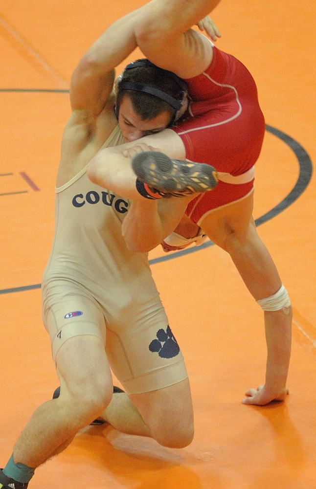 Mount Blue’s Nick Hickey, left, and Cony’s Victor Tapia-Smith compete in a 160-pound championship semi-finals match during the Tiger Invitational on Saturday December 14, 2013 in the John A. Bragoli Memorial Gym in Gardiner. Hickey eventually pinned his opponent to win in overtime.