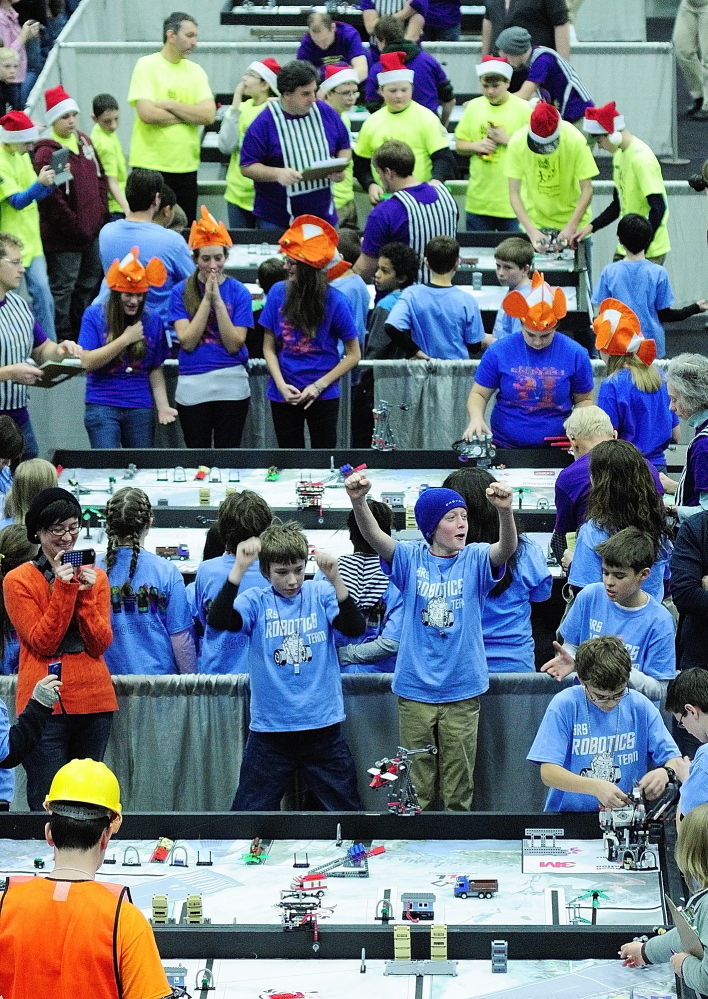 COMPETITION: Teams cheer as their robots perform tasks on tables during Maine’s FIRST® LEGO® League Championship at the Augusta Civic Center on Saturday.