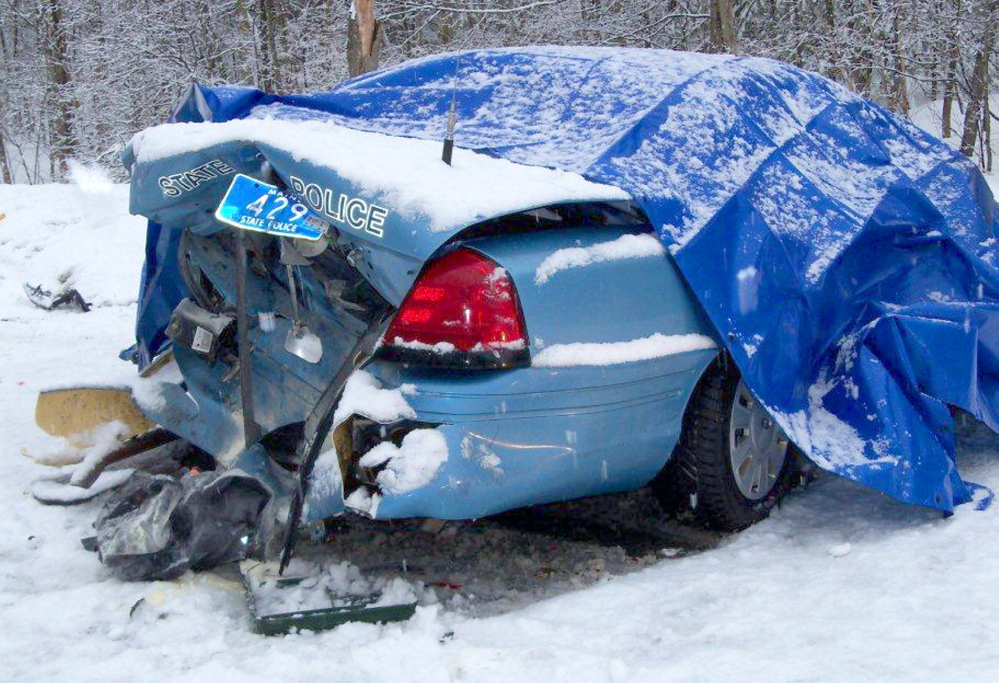 MOVE OVER: State Trooper Robert Cjeka was trapped in his cruiser in March 2011 after his vehicle was rear ended by an empty logging truck while stopped on the side of the road in Livermore Falls. Police are renewing calls for motorists to slow down and move over when approaching an emergency vehicle after several State Police cruisers were struck in recent weeks. Cjeka escaped serious injury.