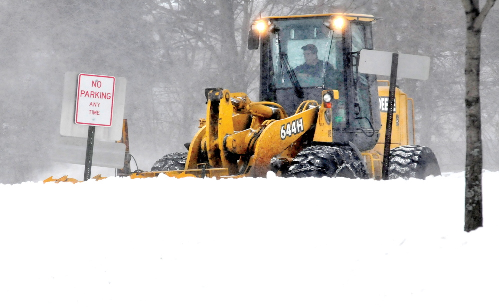 MAKE WAY: Chris DeMerchant of the Waterville Public Works department clears snow off Silver Street during Sunday’s snowfall. Plows, sand trucks and graders were out in full force.