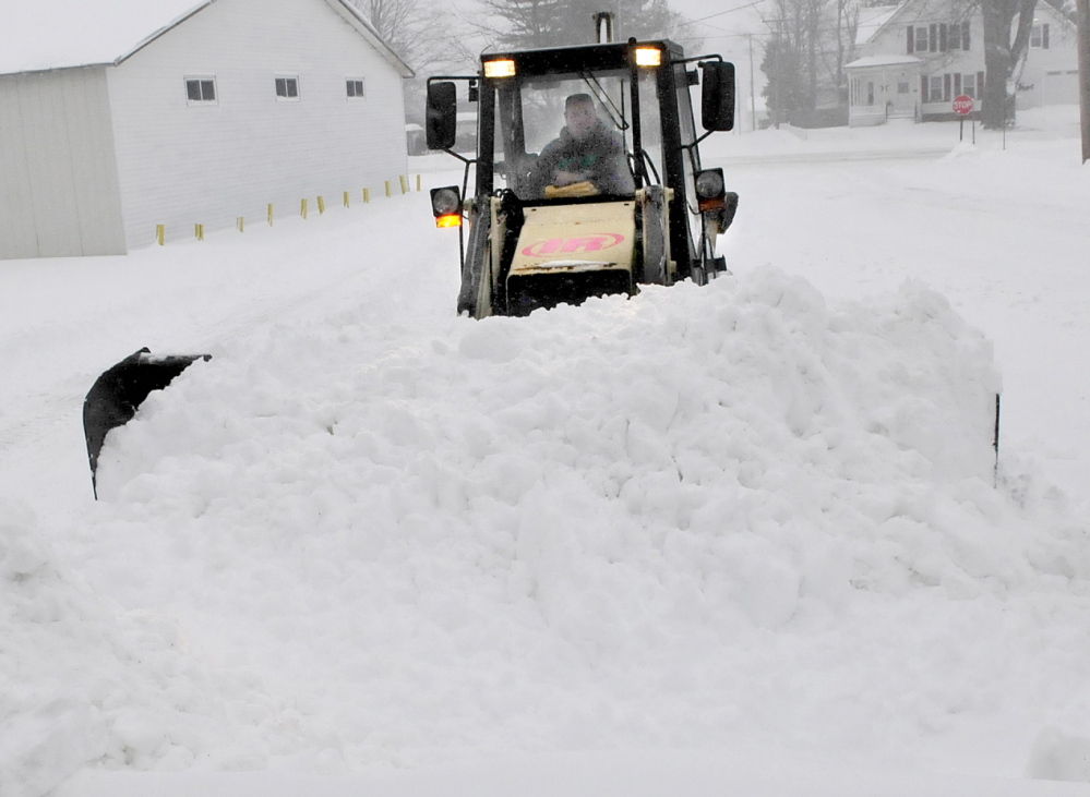 MAKING MOUNTAINS: Dan Misner II of Misner Lawn Care creates a mountain of snow while plowing in Fairfield during the snowstorm on Sunday.