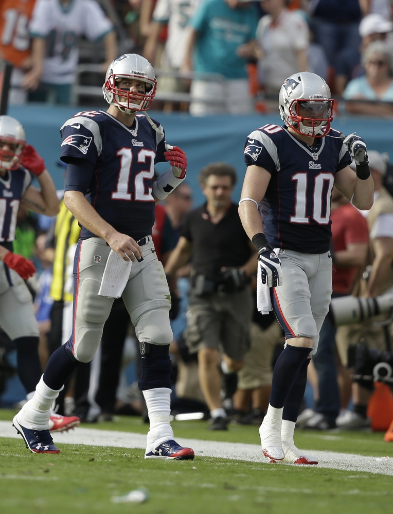 TOUGH ENDING: New England Patriots quarterback Tom Brady (12) and New England Patriots wide receiver Austin Collie (10) come off the field after a pass intended for Collie was intercepted by Miami Dolphins’ Michael Thomas late in the fourth quarter of the Dolphins’ 24-20 win Sunday in Miami Gardens, Fla.