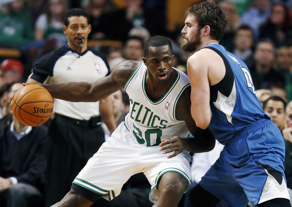 Boston Celtics’ Brandon Bass (30) moves against Minnesota Timberwolves’ Kevin Love (42) in the first quarter of Monday's NBA game in Boston.