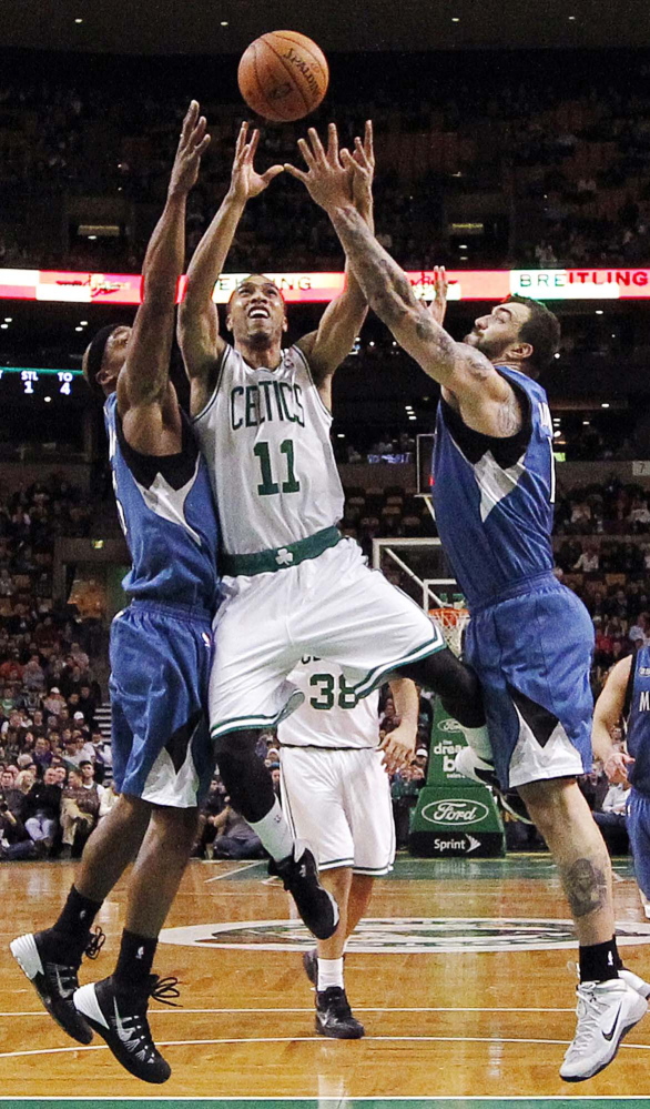 Boston Celtics’ Courtney Lee (11) drives for the basket between Minnesota Timberwolves’ Dante Cunningham, left, and Nikola Pekovic in the second quarter Monday.
