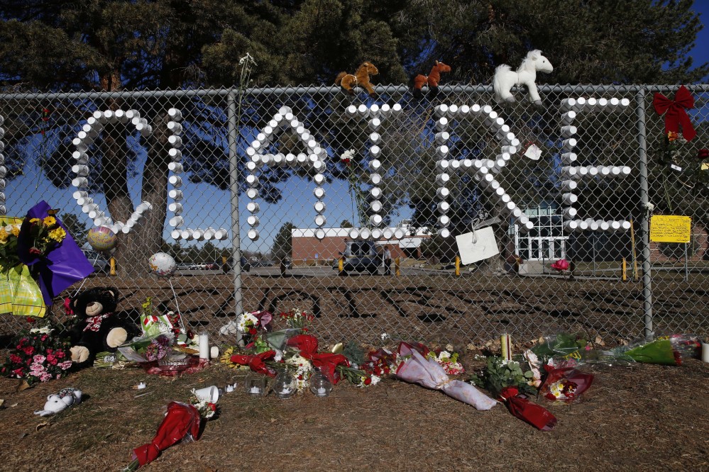 A makeshift tribute site bears the name of severely wounded student Claire Davis, who was shot by a classmate during school three days earlier in an attack, in front of Arapahoe High School in Centennial, Colo., Monday, Dec. 16, 2013. Davis, age 17, was shot in the head at close range with a shotgun, and remains in a coma.