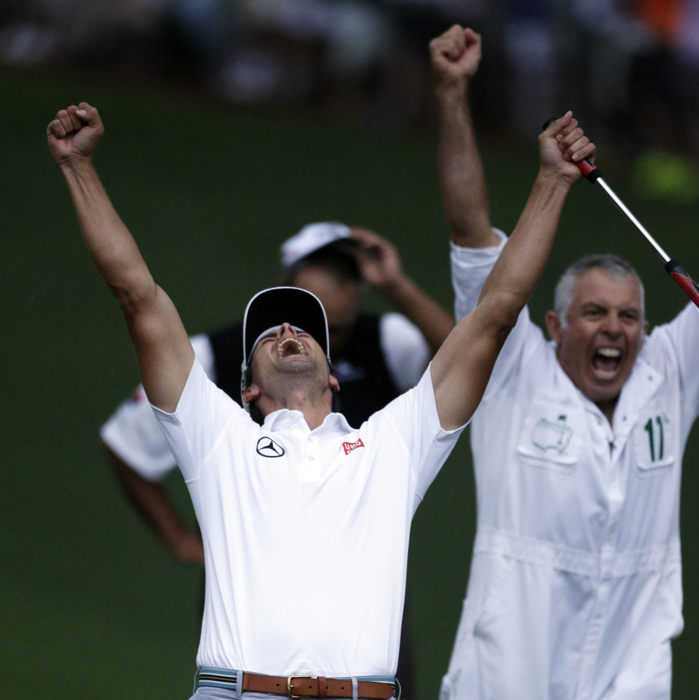 FILE - In this April 14, 2013 file photo, Adam Scott, of Australia, front, celebrates with caddie Steve Williams after making a birdie putt on the second playoff hole to win the Masters golf tournament in Augusta, Ga. Every major championship features a signature shot, some easier to define than others. And with every major champion, there is another shot that is equally pleasing to them even if hardly anyone else noticed. (AP Photo/Darron Cummings, File)