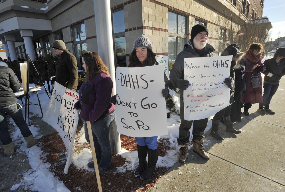 Demonstrators gather Tuesday outside the Department of Health and Human Services office on Marginal Way in Portland to protest the state’s relocation plan. “The trip to South Portland is long, even by bus,” said protester Jim Devine.