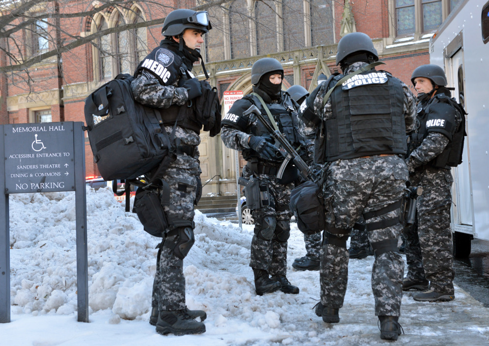 Tactical police assemble outside a building at Harvard University in Cambridge, Mass., Monday, Dec. 16, 2013. Four buildings on campus were evacuated after campus police received an e-mail that explosives may have been placed inside, interrupting final exams.
